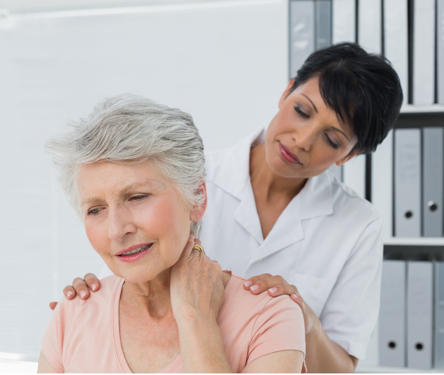 Healthcare professional assessing neck and shoulder discomfort